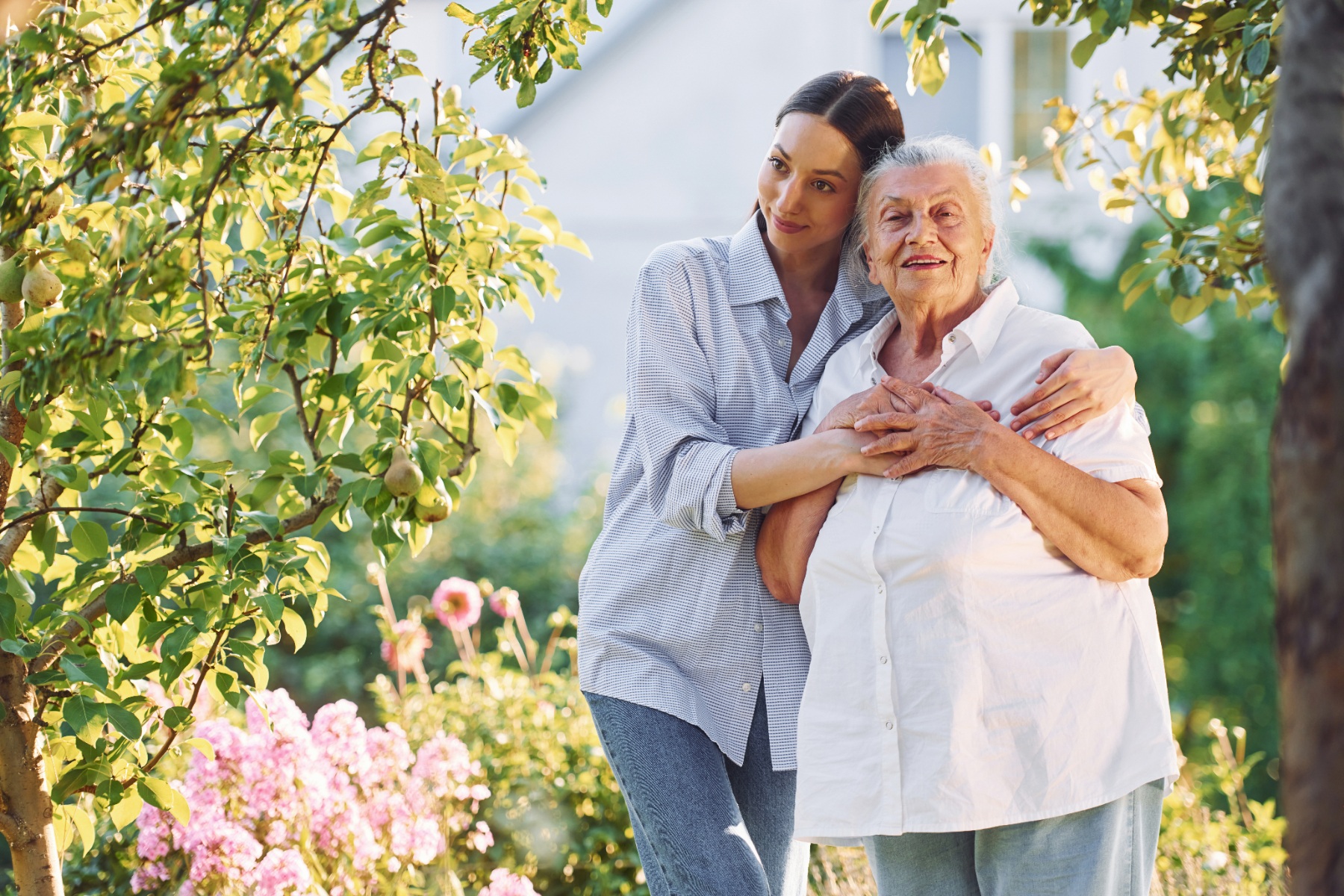 A young woman tenderly caring for her parent