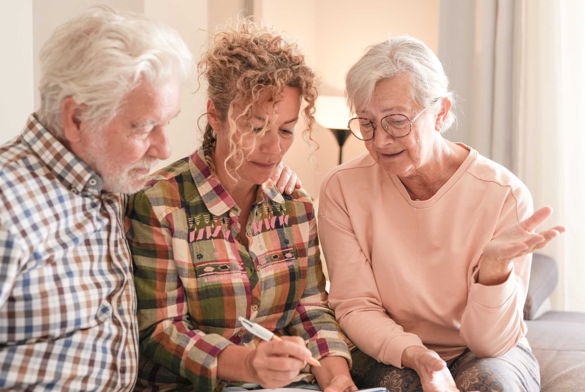 Senior couple and caregiver sharing a warm moment together